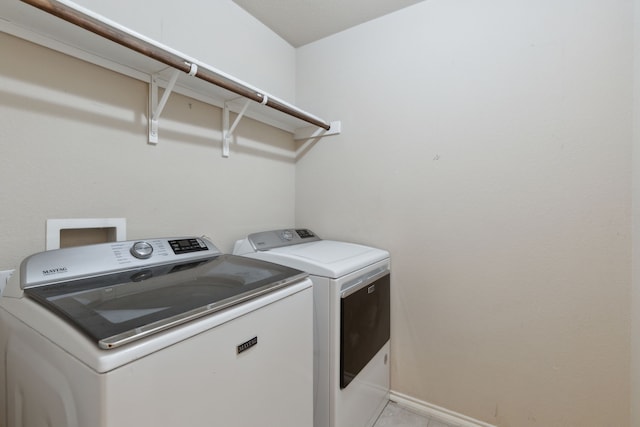 clothes washing area featuring washing machine and clothes dryer