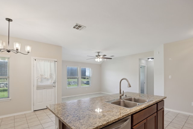 kitchen featuring light tile patterned floors, visible vents, pendant lighting, and a sink