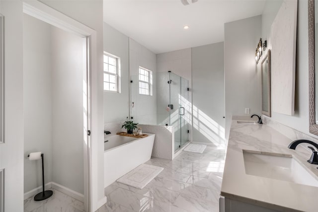 full bathroom with a soaking tub, marble finish floor, a sink, and a shower stall