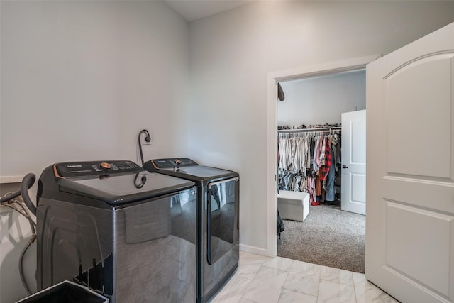 clothes washing area with marble finish floor, baseboards, and separate washer and dryer