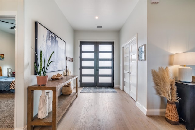 entrance foyer with light wood-style flooring, visible vents, and baseboards