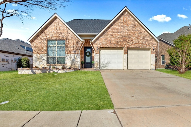 view of front of house featuring a garage and a front lawn