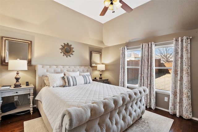 bedroom with vaulted ceiling, dark hardwood / wood-style floors, and ceiling fan