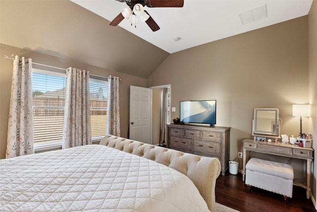 bedroom with ceiling fan, lofted ceiling, and dark hardwood / wood-style floors