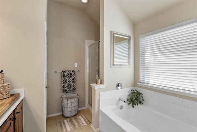 bathroom featuring tile patterned floors, separate shower and tub, and vaulted ceiling