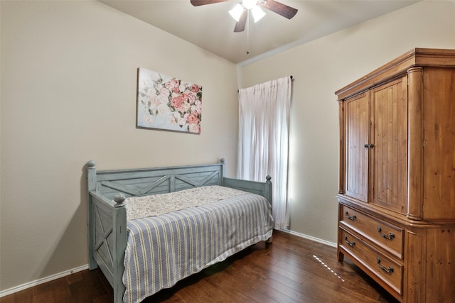 bedroom with dark hardwood / wood-style floors and ceiling fan