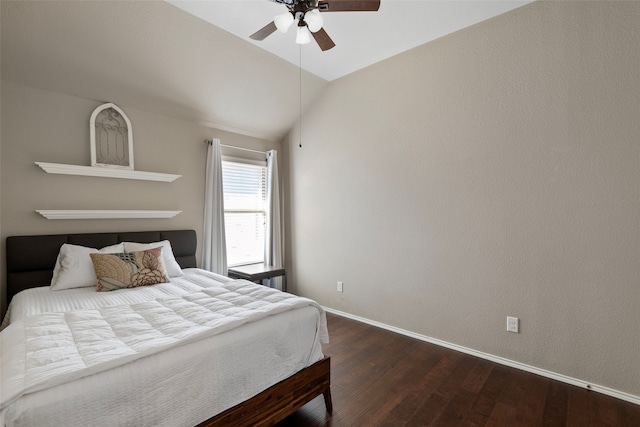 bedroom featuring vaulted ceiling, dark hardwood / wood-style floors, and ceiling fan