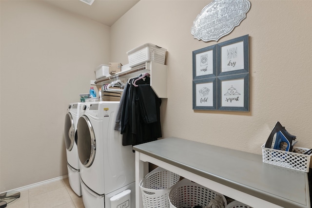 laundry room with washing machine and dryer and light tile patterned floors