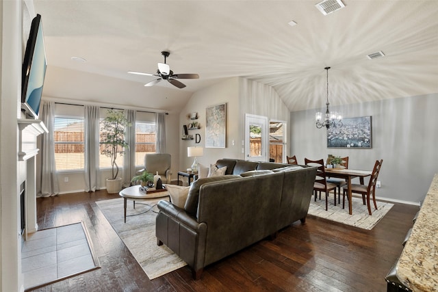 living room featuring ceiling fan with notable chandelier, vaulted ceiling, and dark hardwood / wood-style floors