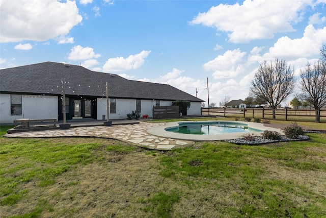 view of swimming pool with a yard and a patio area