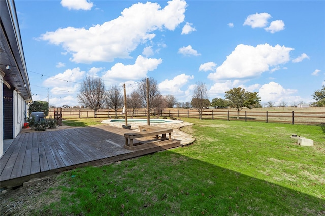 view of yard with a pool side deck and a rural view