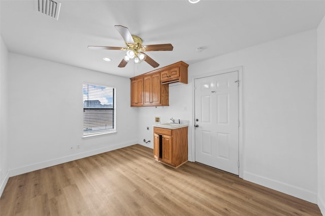 kitchen with sink, light hardwood / wood-style floors, and ceiling fan