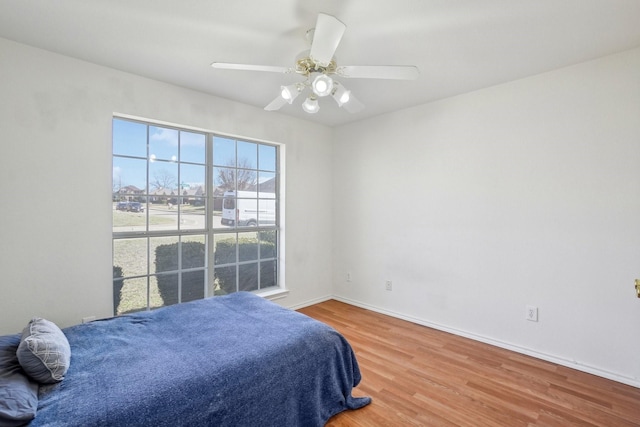 bedroom featuring hardwood / wood-style flooring and ceiling fan