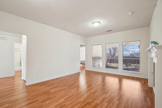 spare room with light hardwood / wood-style flooring