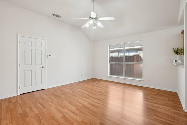 unfurnished room with ceiling fan, lofted ceiling, and light wood-type flooring