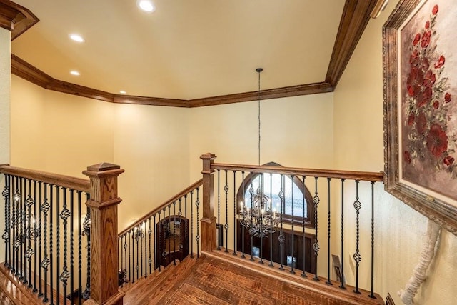 stairway featuring ornamental molding and a notable chandelier