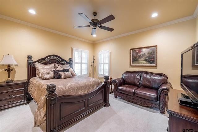 carpeted bedroom featuring crown molding and ceiling fan