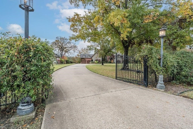 view of gate featuring a yard