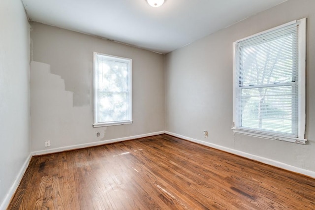 unfurnished room with wood-type flooring