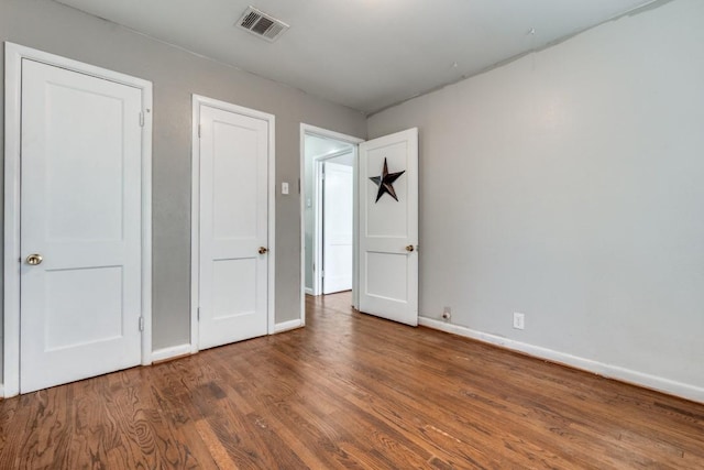 unfurnished bedroom with hardwood / wood-style floors