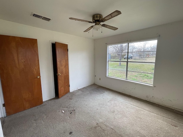 unfurnished bedroom featuring ceiling fan and carpet floors