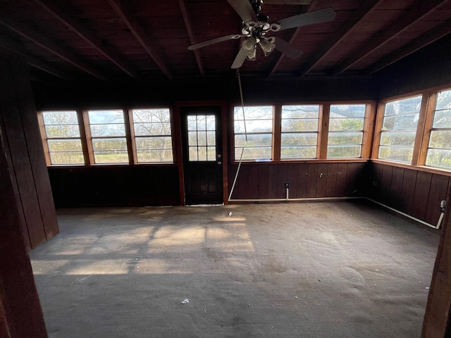 unfurnished sunroom with ceiling fan and lofted ceiling