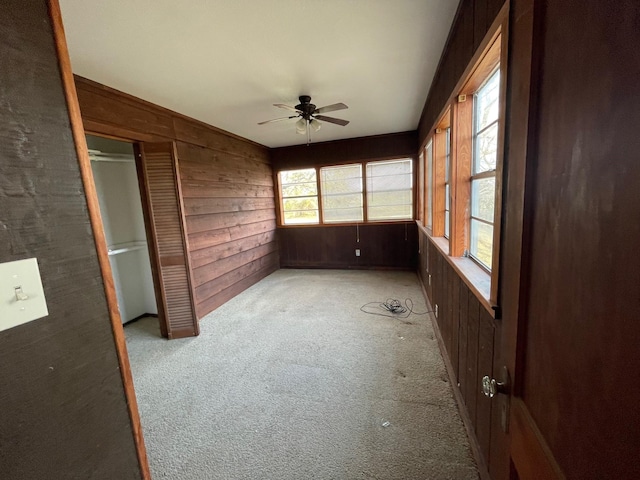 unfurnished sunroom featuring ceiling fan