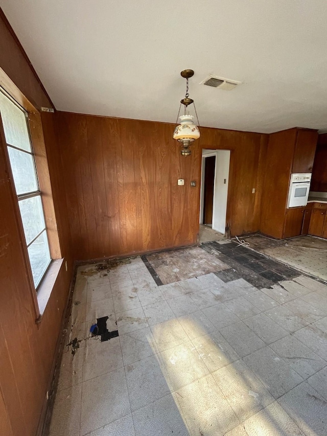 empty room featuring wood walls