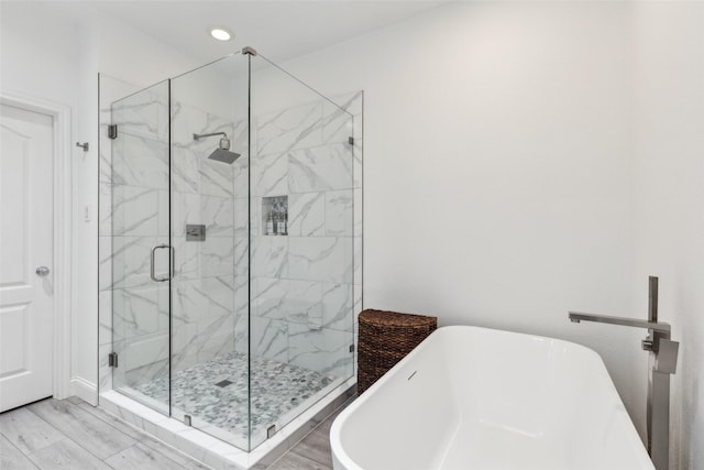 bathroom with separate shower and tub