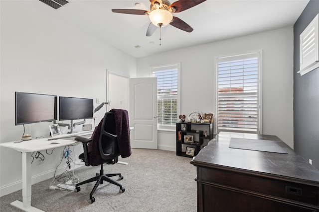 carpeted office space featuring ceiling fan