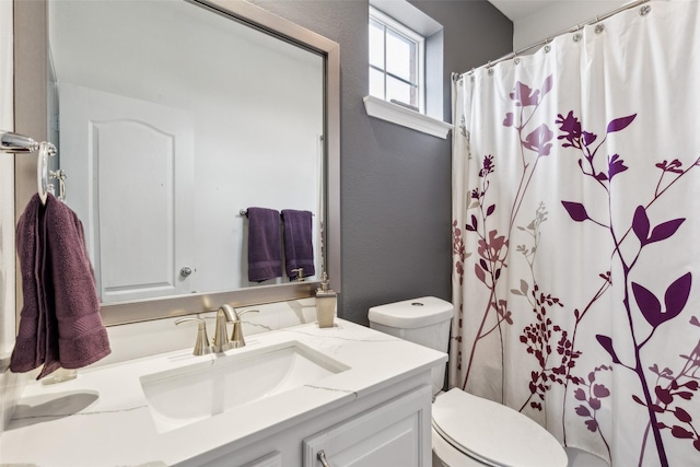 bathroom with vanity, toilet, and a shower with shower curtain