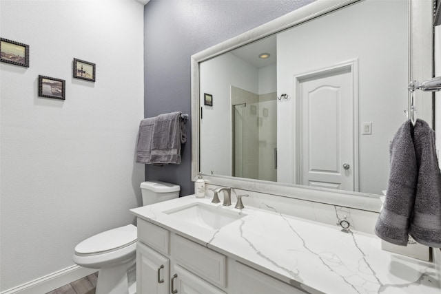 bathroom with hardwood / wood-style flooring, vanity, toilet, and an enclosed shower