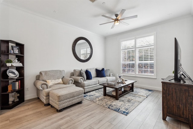 living room with crown molding, light hardwood / wood-style flooring, and ceiling fan