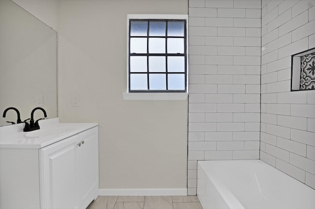 bathroom featuring shower / bath combination, vanity, and baseboards
