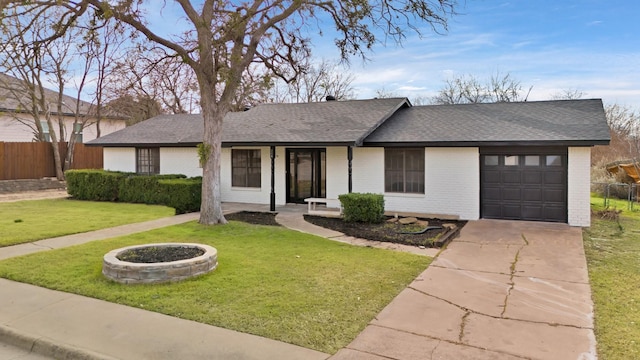 single story home with a garage and a front lawn