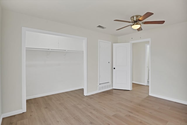 unfurnished bedroom featuring light wood-style floors, visible vents, a closet, and baseboards