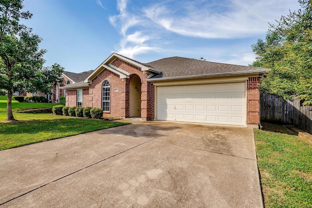 single story home featuring a garage and a front lawn