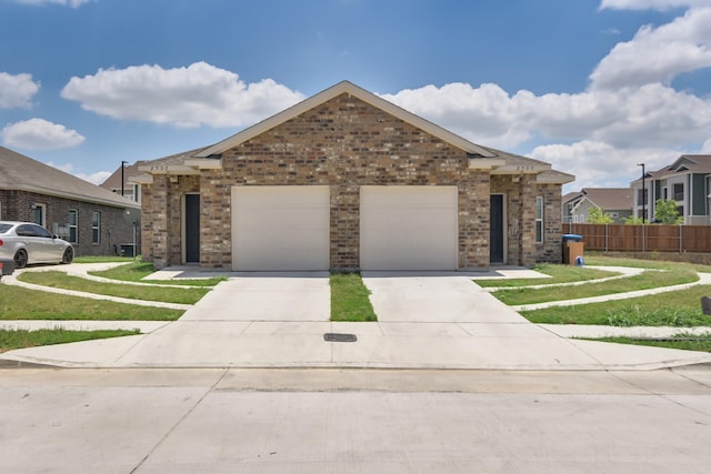 view of front of home featuring a garage and a front yard