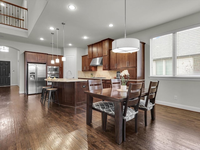 dining room with dark hardwood / wood-style floors and sink