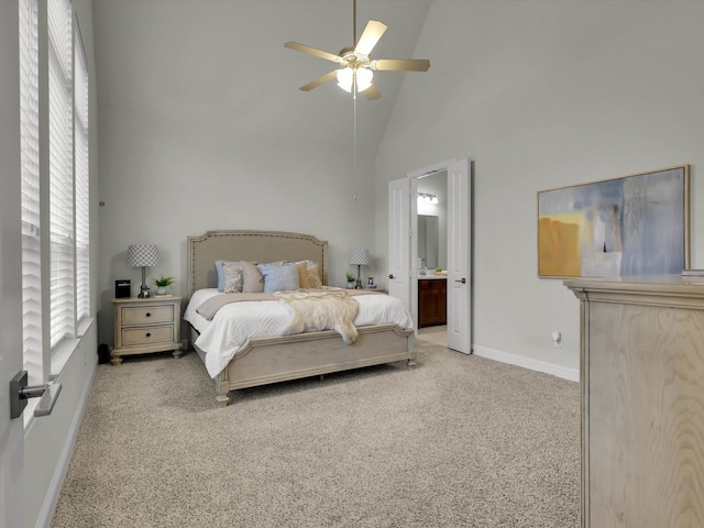 carpeted bedroom featuring ceiling fan, connected bathroom, and high vaulted ceiling