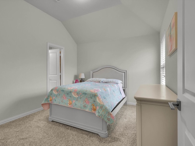 carpeted bedroom with vaulted ceiling