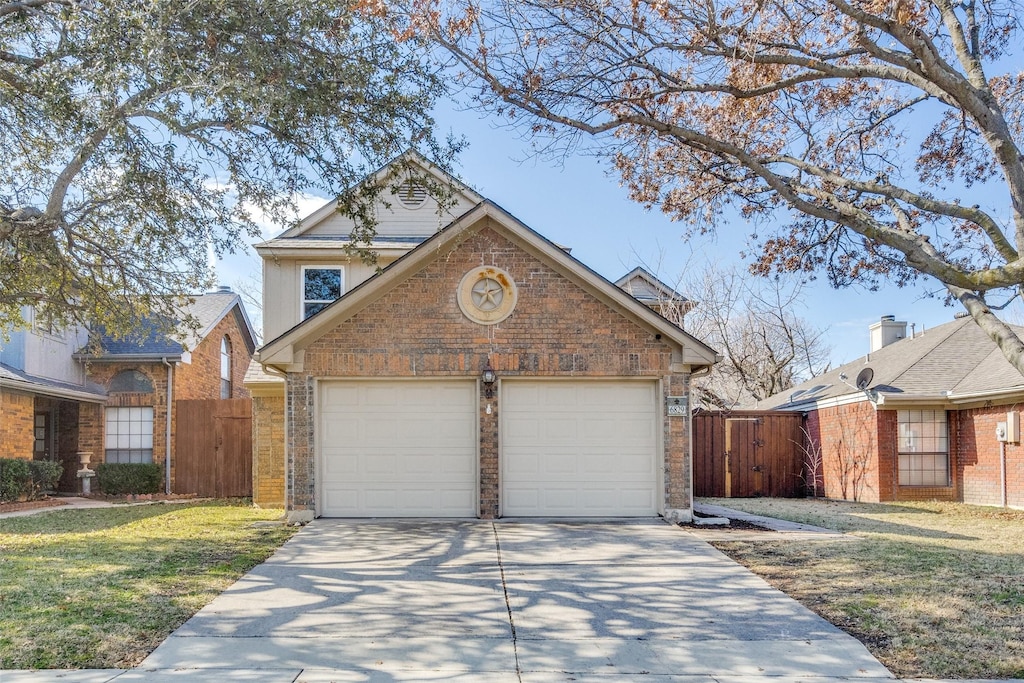 view of front property featuring a garage and a front yard