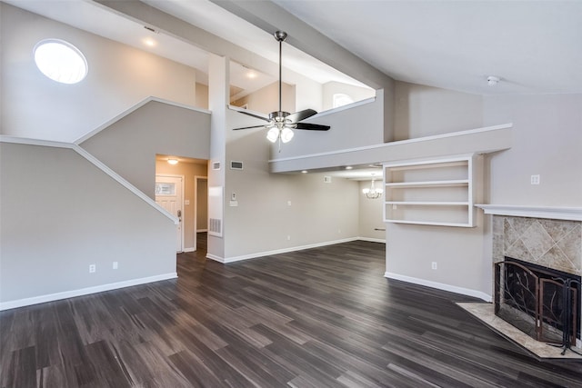 unfurnished living room with a tiled fireplace, dark wood-type flooring, high vaulted ceiling, and ceiling fan