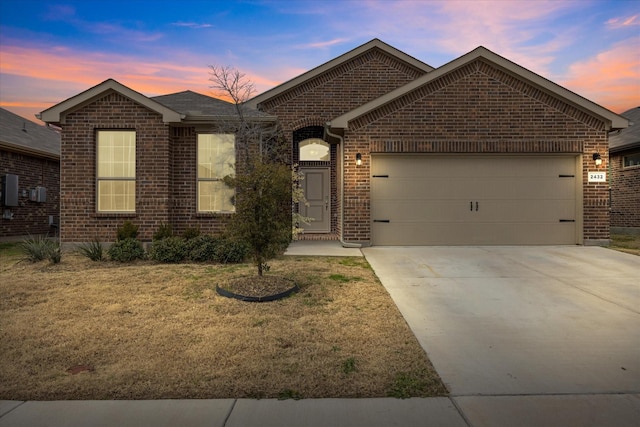 view of front facade with a yard and a garage