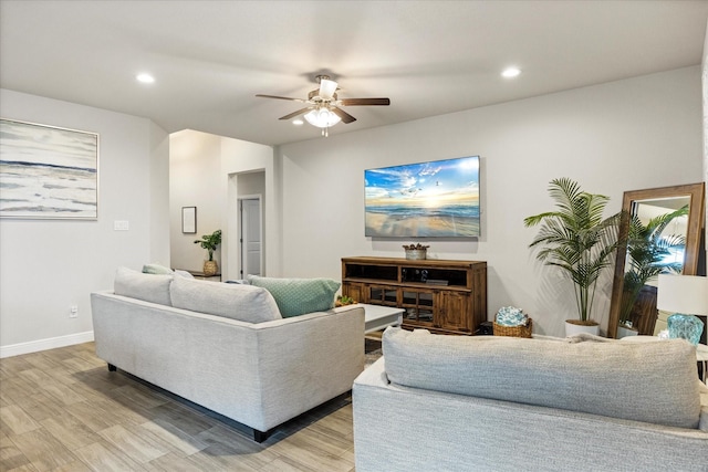 living room with ceiling fan and light wood-type flooring