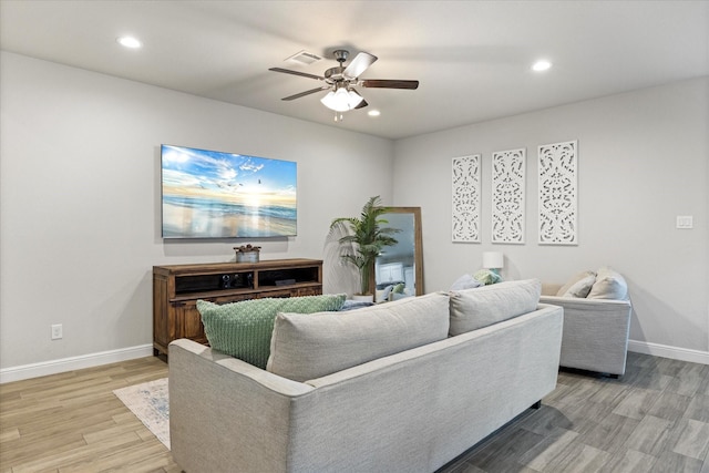 living room with wood-type flooring and ceiling fan