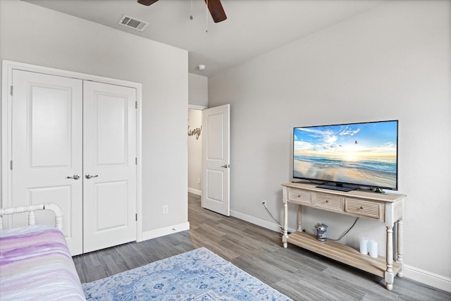 bedroom featuring hardwood / wood-style flooring, a closet, and ceiling fan