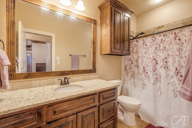 bathroom featuring tile patterned floors, vanity, and toilet