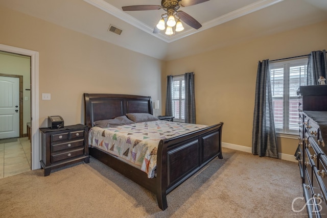 carpeted bedroom with crown molding, ceiling fan, and a raised ceiling