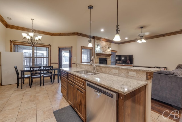 kitchen with pendant lighting, refrigerator, dishwasher, an island with sink, and sink